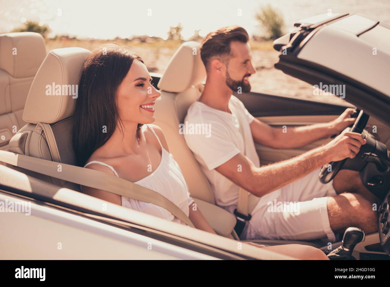 Photo of husband wife people ride vehicle road service car steering ...
