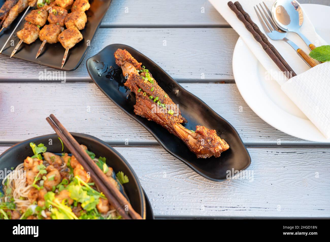 Chinese lamb barbeque served on a plate in a restaurant top view. Asian barbecue street food abstract, popular night snack Stock Photo