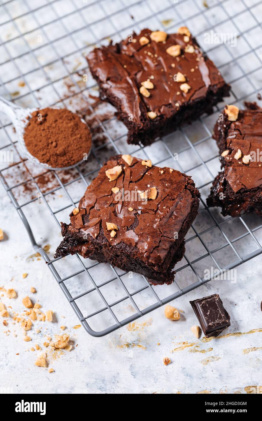 Chocolate fudge brownies with hazelnut crumbs on top, on a tray with