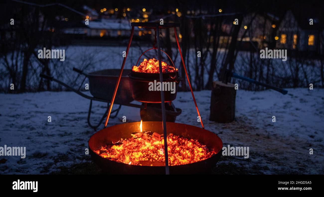 cooking a meal outdoor on openfire. it´s an dutch oven Stock Photo