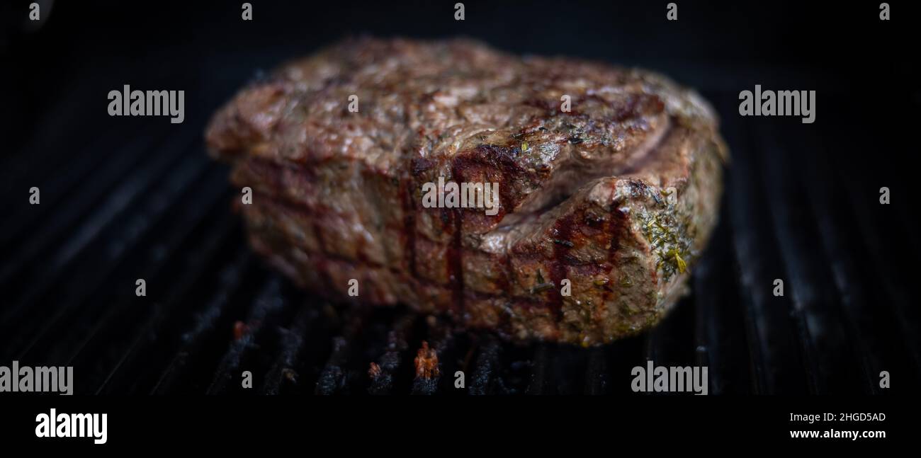 a big roastbeef on a gas griller Stock Photo