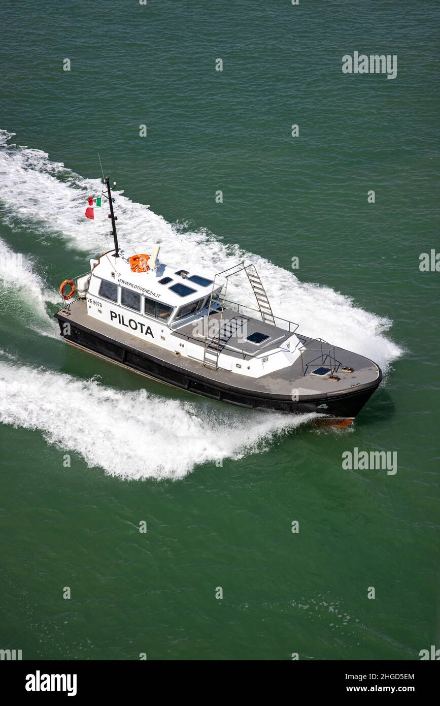 small boat who is guiding a big ferry Stock Photo
