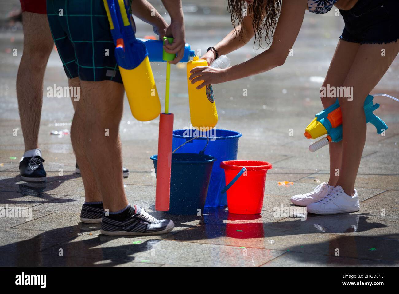 Adults play with water guns Stock Photo