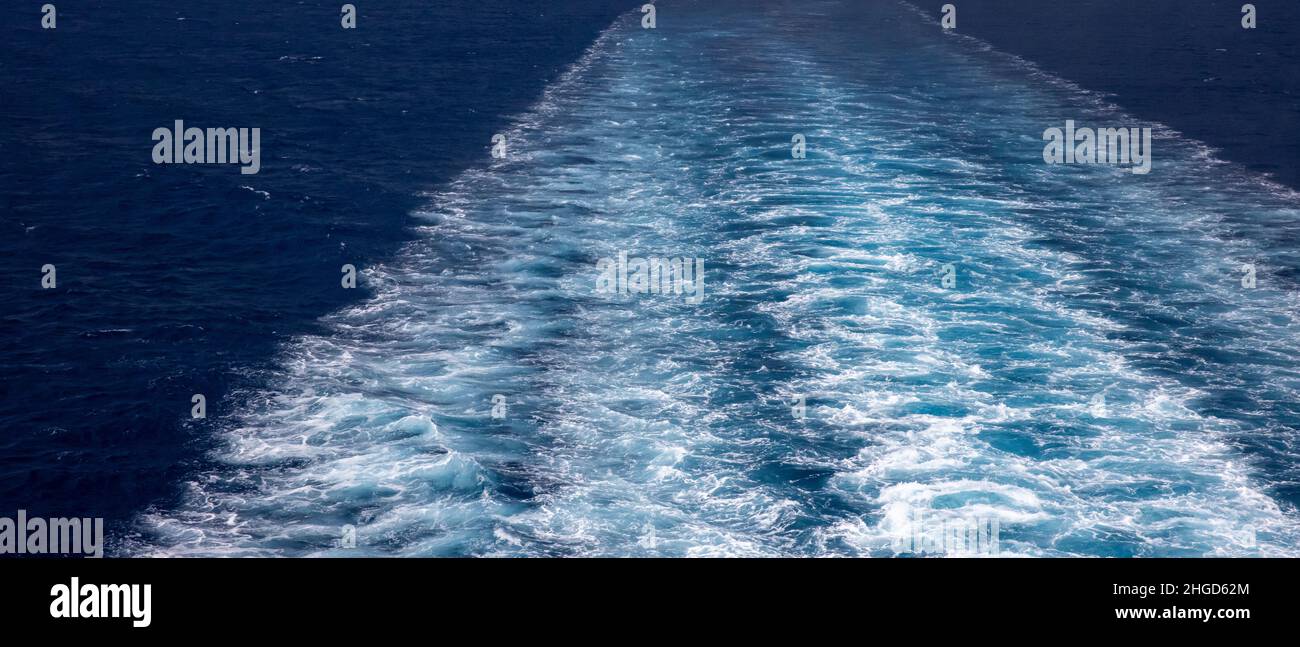 spray behind the ferry on the wide sea Stock Photo