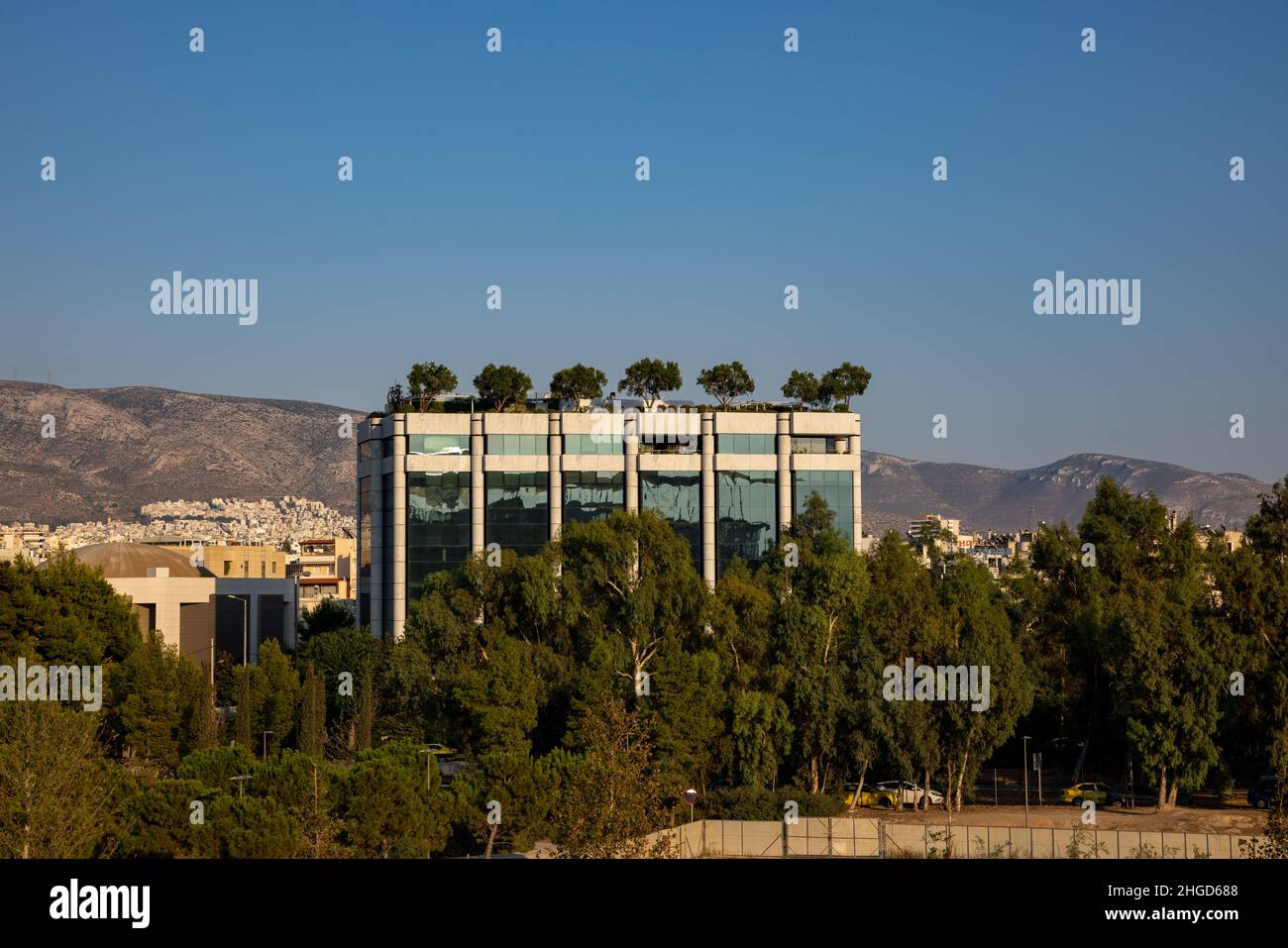 house with trees on the roof and surrounded  by trees in athens Stock Photo