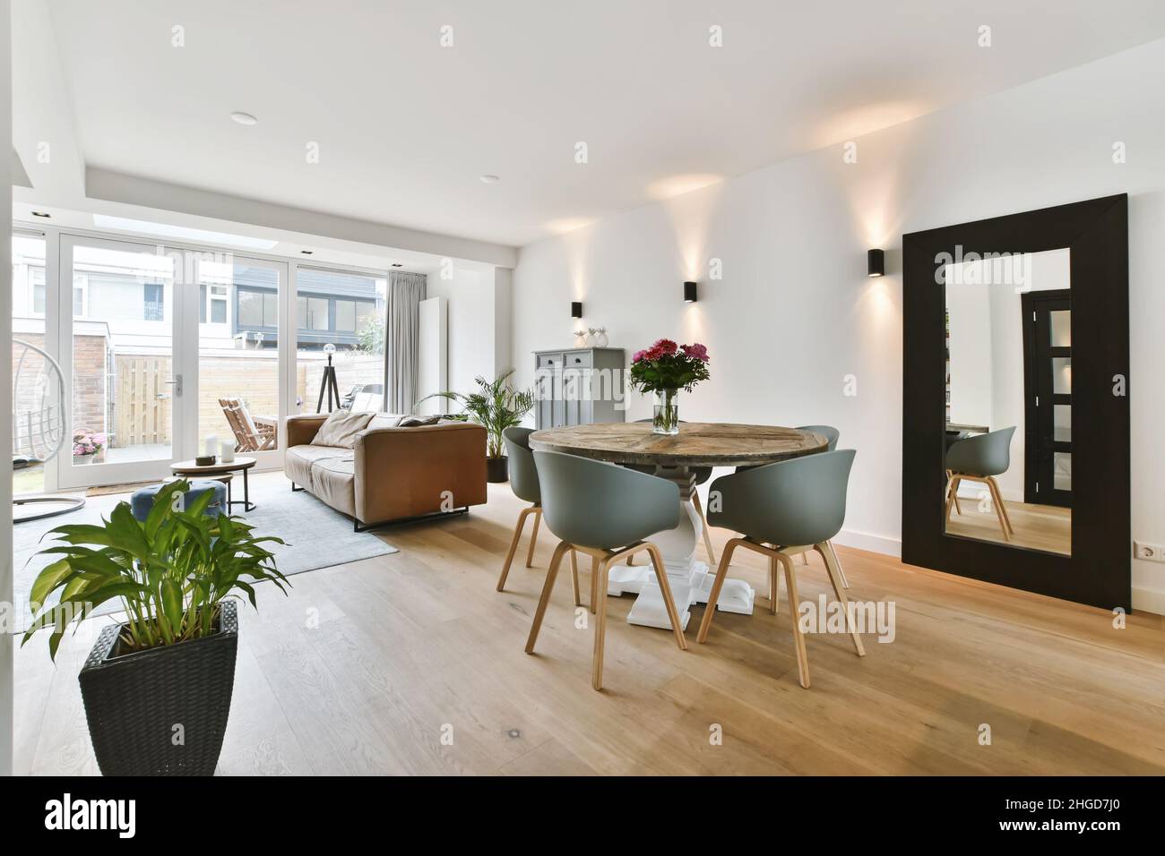 Lovely living room combined with a dining area with a round table Stock ...