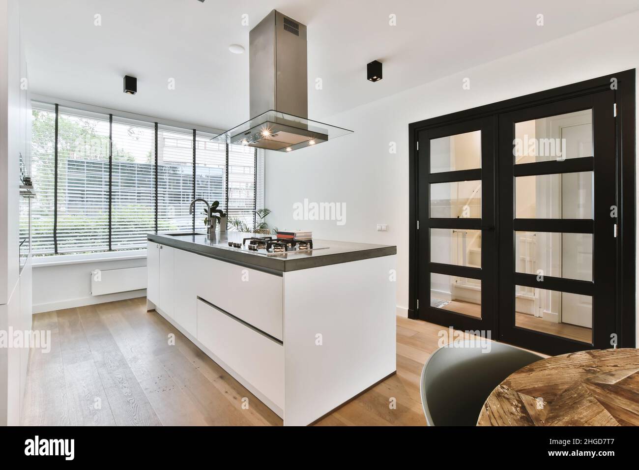 Lovely kitchen with black doors in a minimalist style Stock Photo Alamy