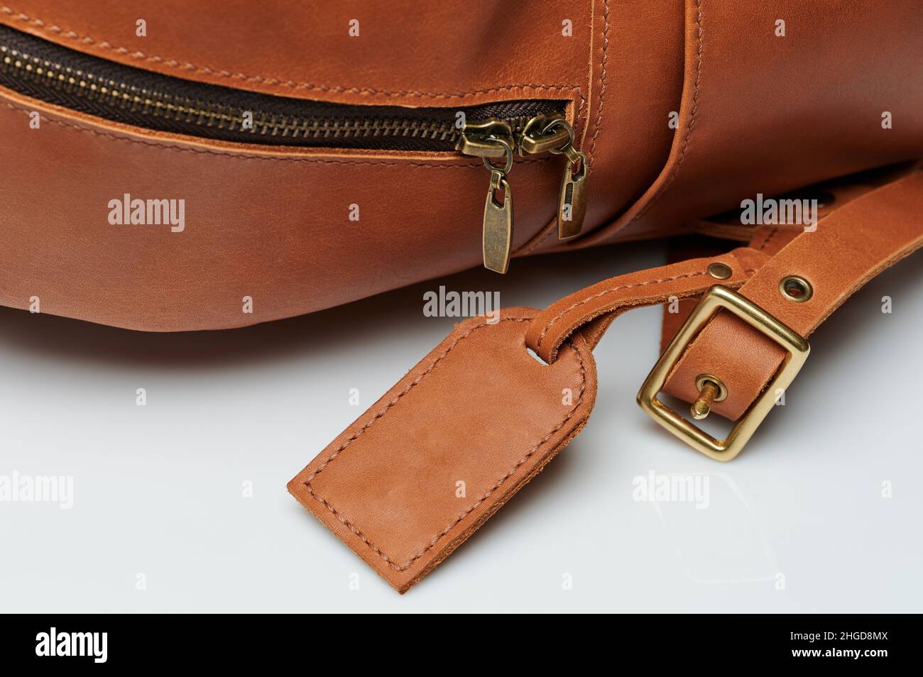 Accessories on brown leather backpack macro close up view Stock Photo