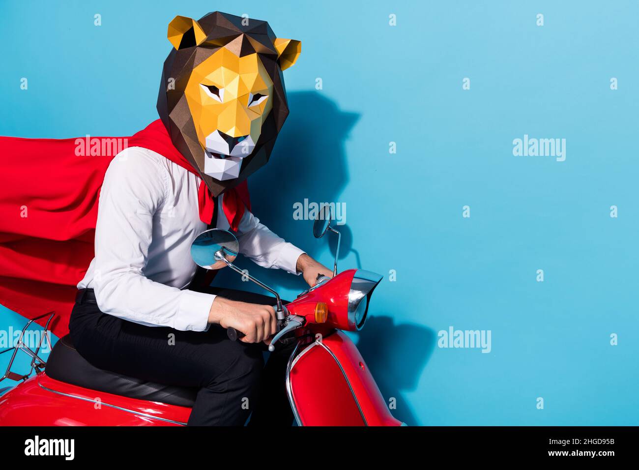 Photo of weird freak fantasy guy in lion mask ride scooter safe world theme festive event isolated over blue color background Stock Photo