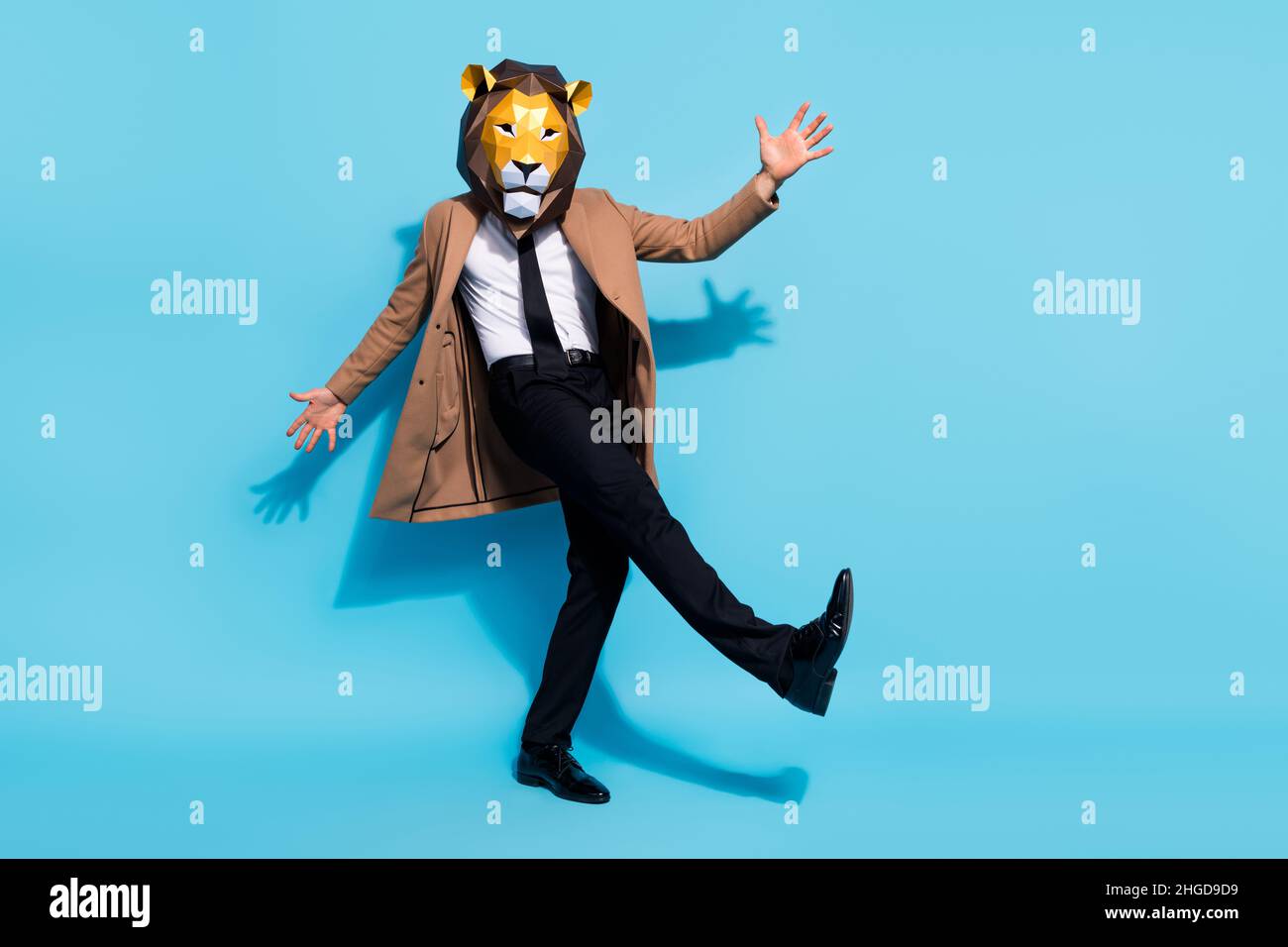 Full body photo of bizarre authentic guy lion mask dance incognito theme costume occasion isolated over blue color background Stock Photo