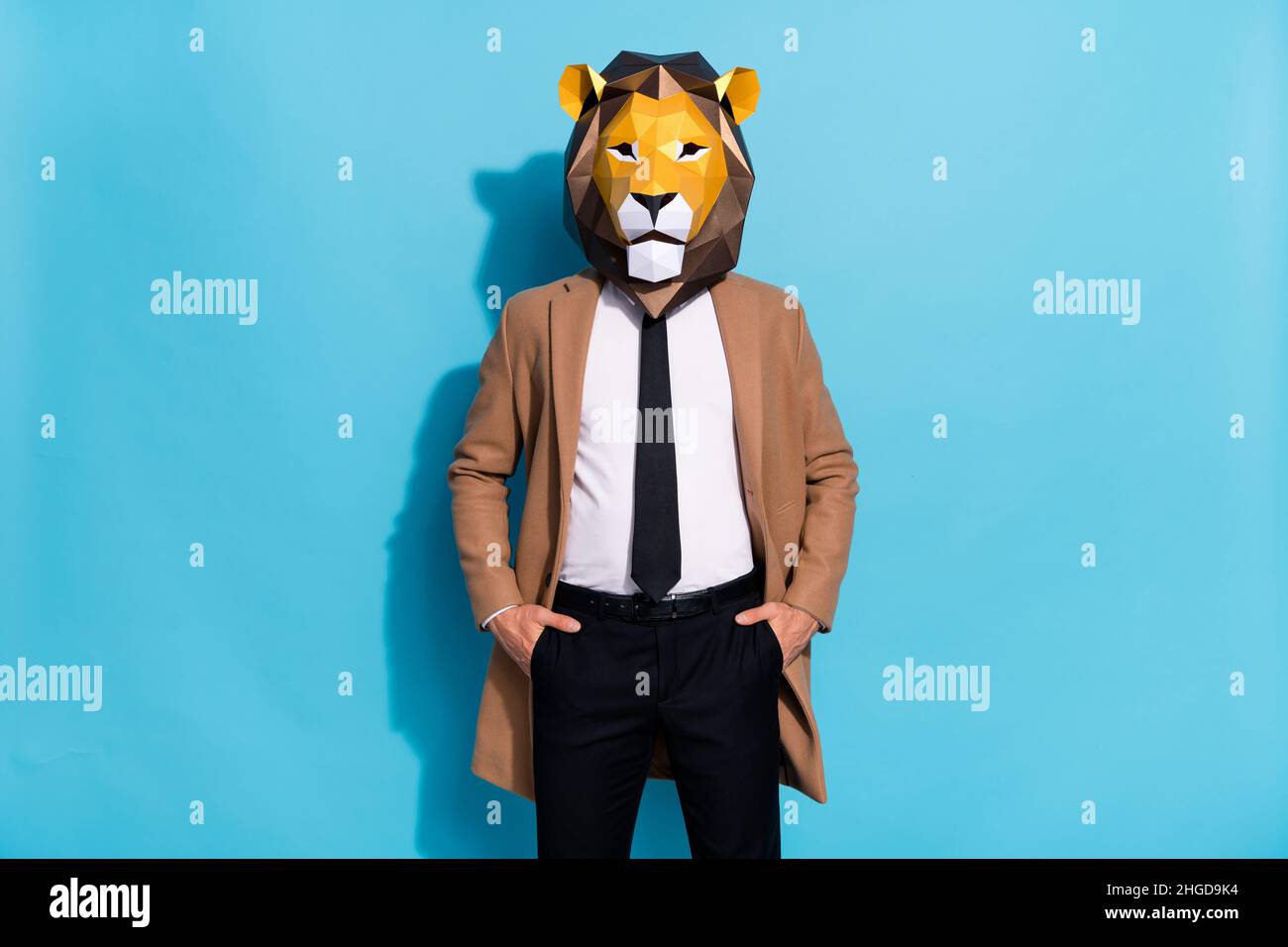 Photo of successful freak lion mask guy put hands pockets trousers isolated over blue color background Stock Photo