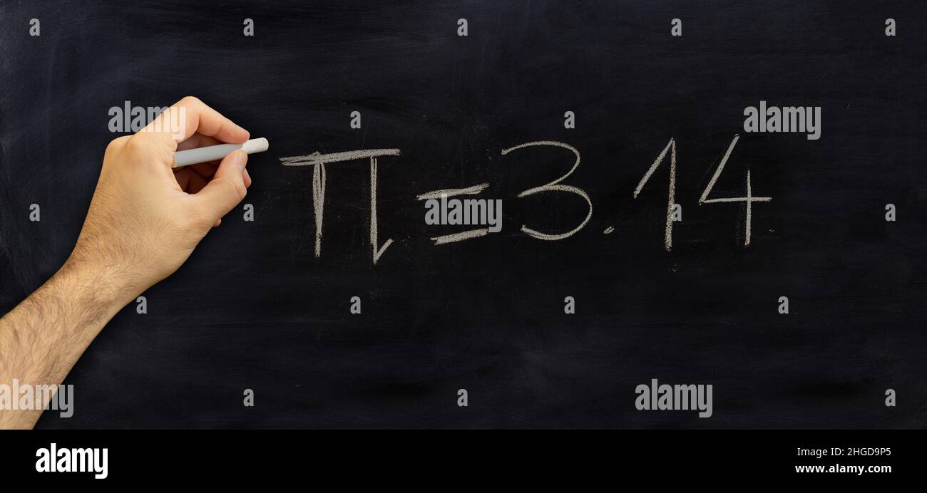 Pi number, mathematical constant chalk drawing on a school black board, Male hand write Greek letter and 3.14 digits with a chalk Stock Photo