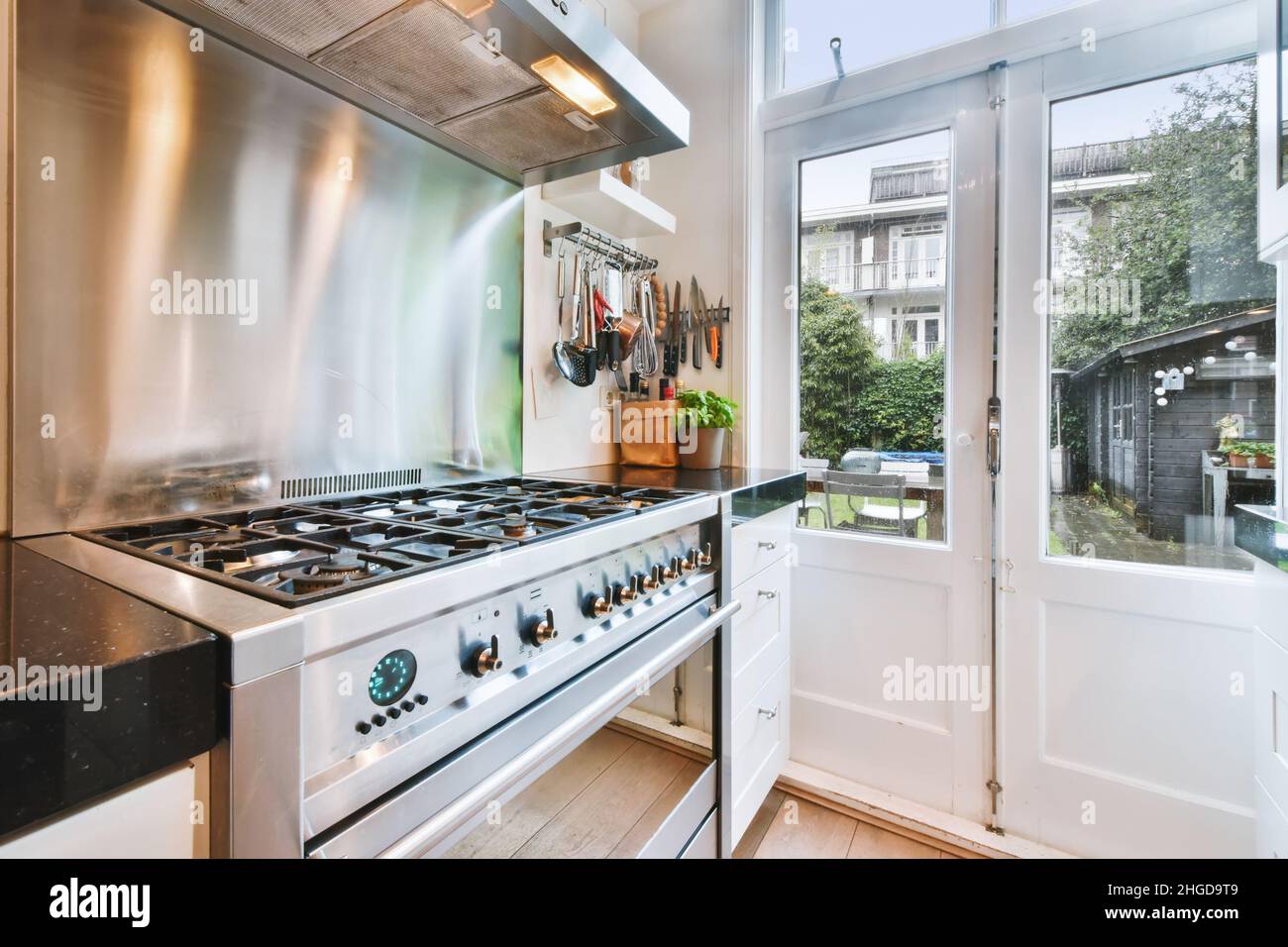 Charming kitchen with black countertop and modern gas stove Stock Photo ...