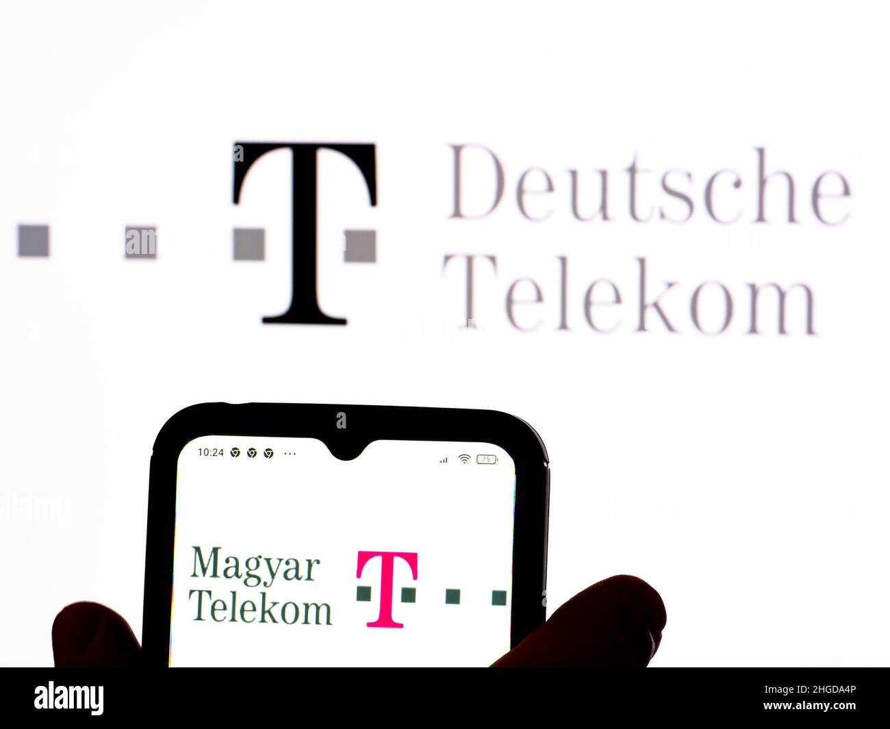 January 19, 2022, Ukraine: In this photo illustration, the Magyar Telekom Telecommunications Public Limited Company logo is seen displayed on a smartphone screen with the Deutsche Telekom AG logo in the background. (Credit Image: © Igor Golovniov/SOPA Images via ZUMA Press Wire) Stock Photo