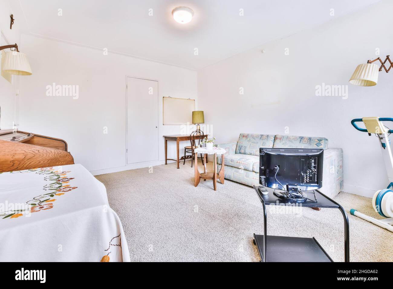 Amazing living room with a small sofa and TV Stock Photo - Alamy