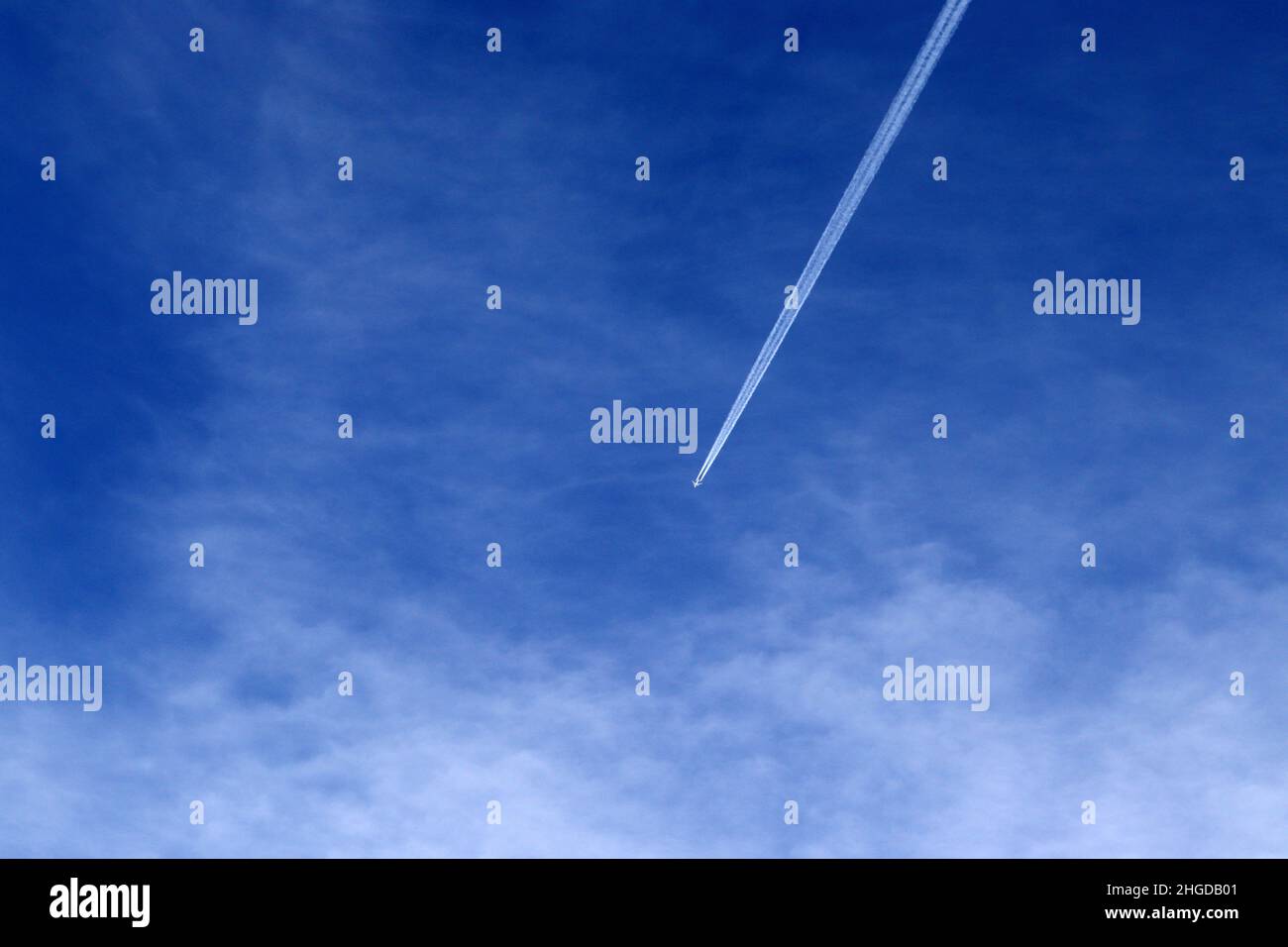 Trace of the high flying plane on the blue sky with white clouds Stock ...