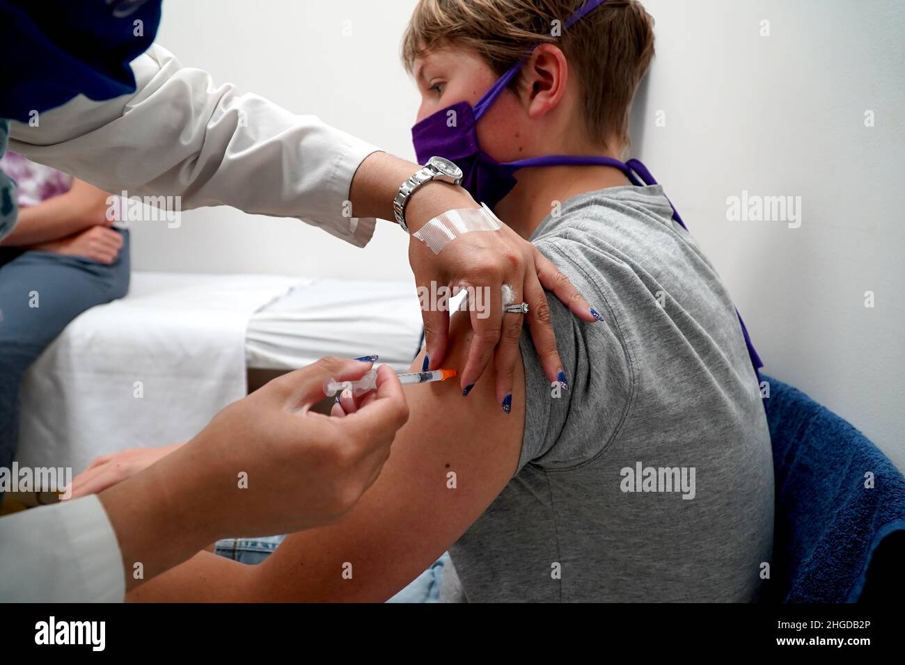 Young teenage boy getting his covid vaccination Stock Photo