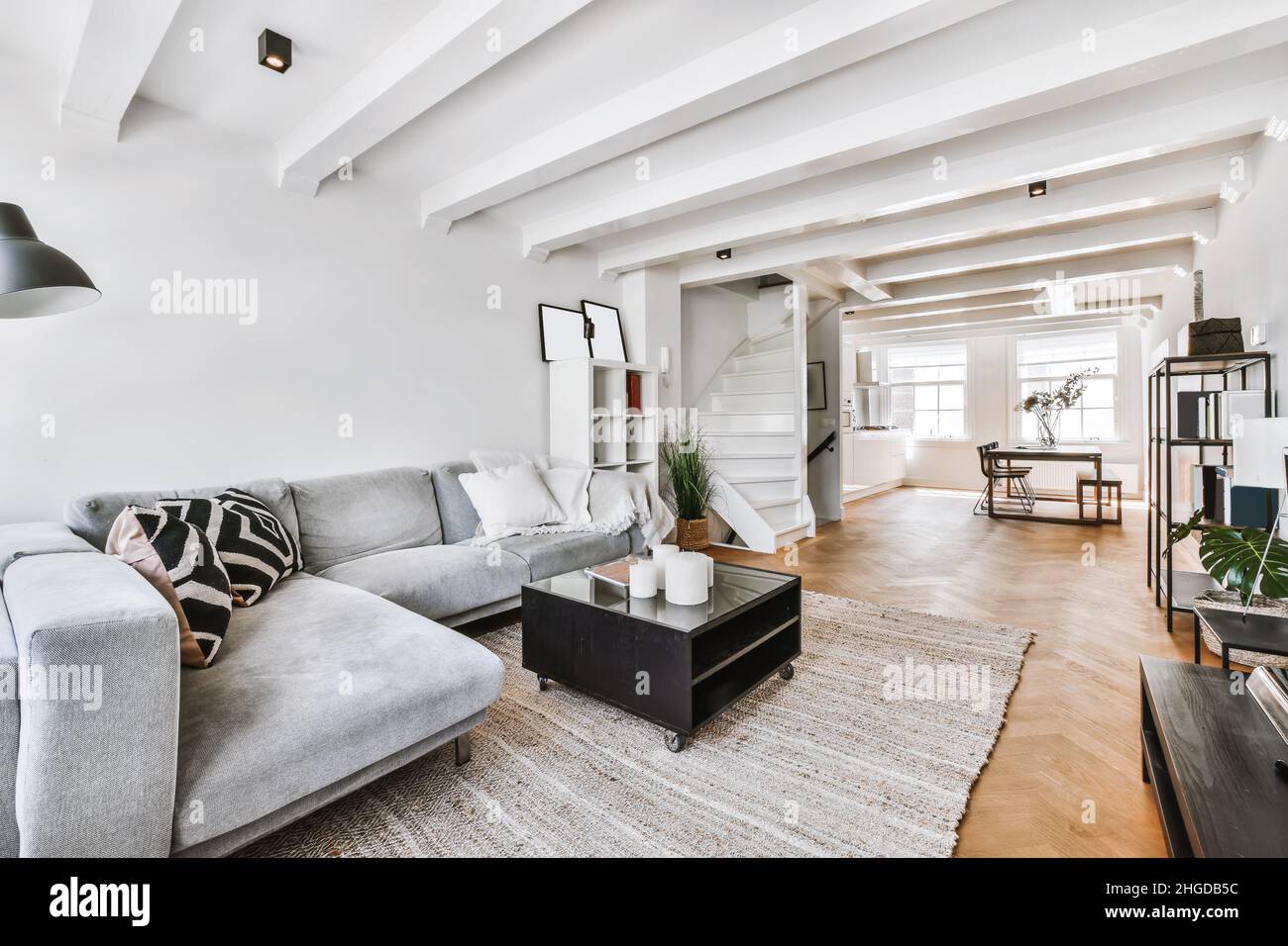 Stylish living room with grey sofa and decorative pillows Stock Photo