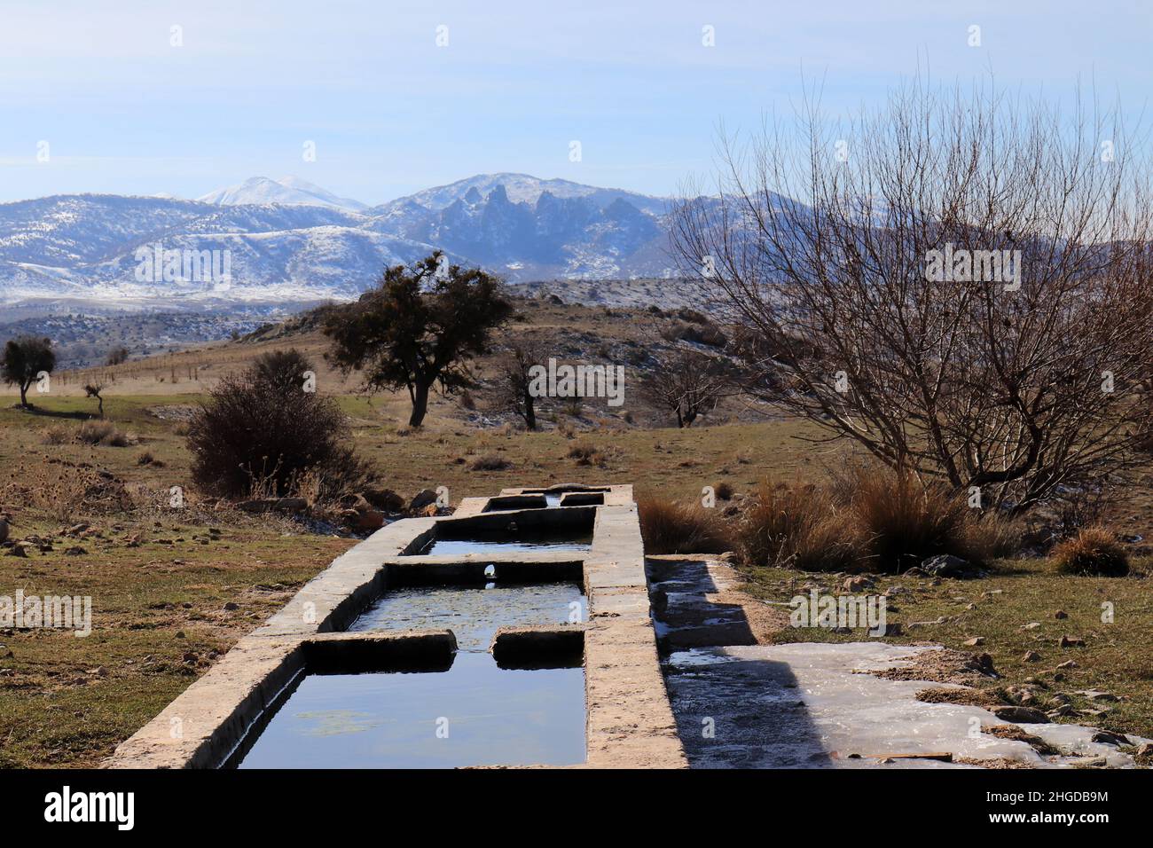stone trough and snowy mountains Stock Photo - Alamy