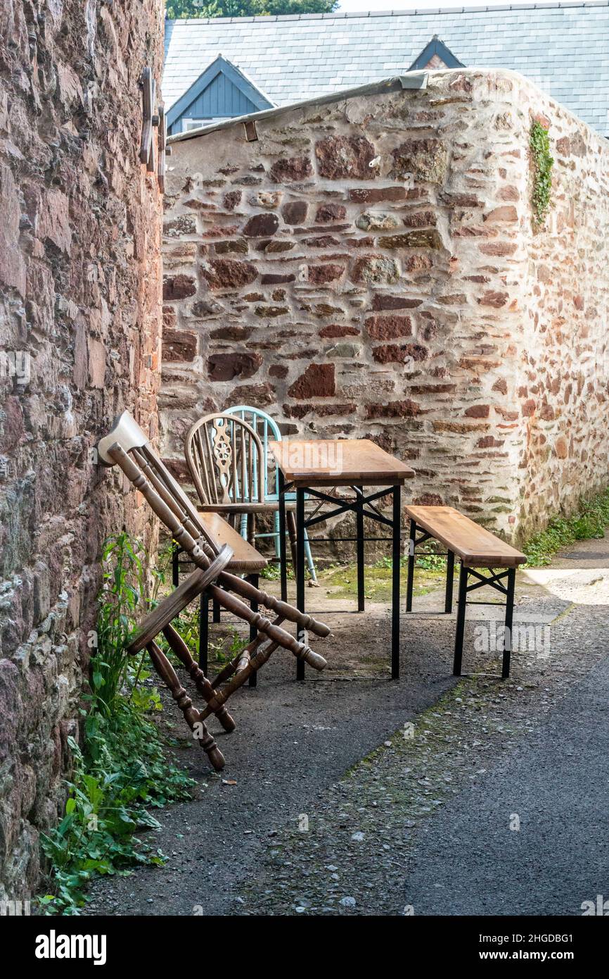 An improvised outdoor seating area in an alley improvised by the Rising Sun pub in Cawsand during the covid pandemic. Stock Photo