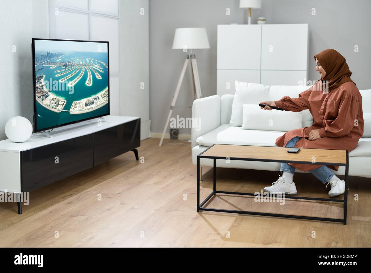 Muslim Woman Watching TV Movie At House Room Stock Photo