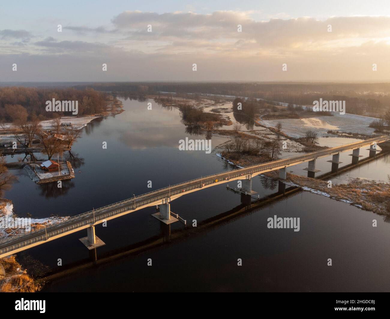 Bridge over the river and town on a calm winter day. Winter. Stock Photo