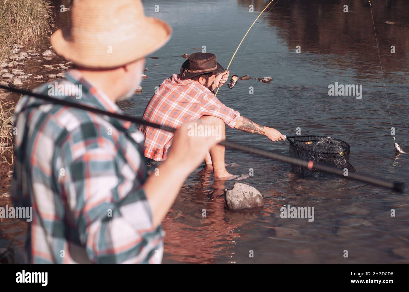 Bearded men catching fish. lear water river. Hobby sport activity ...