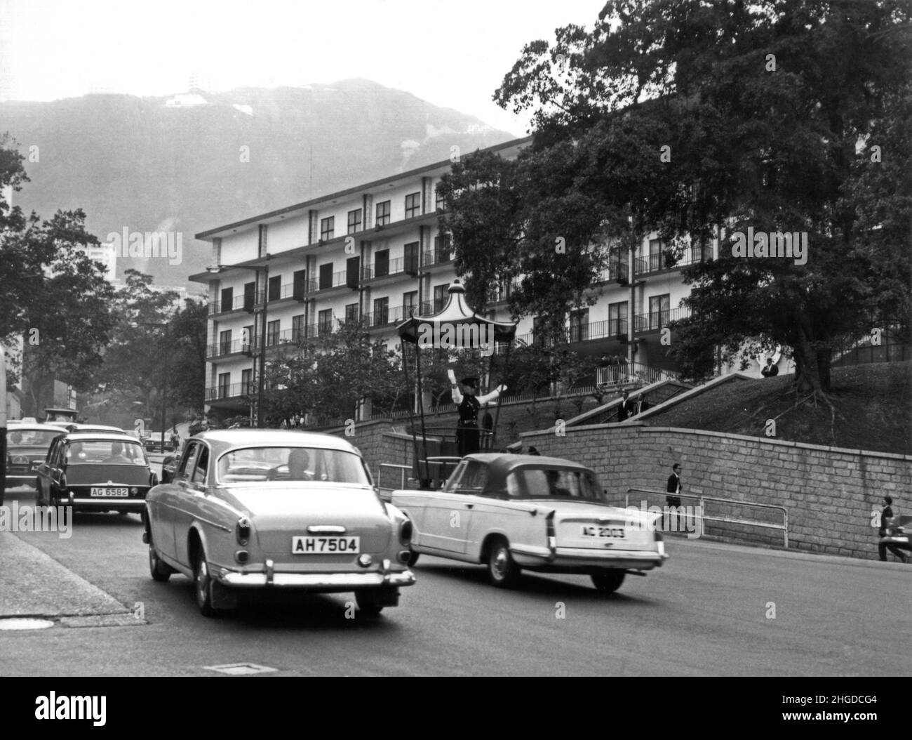Hong Kong island towards the Peak with traffic control police and cars 1967 Stock Photo