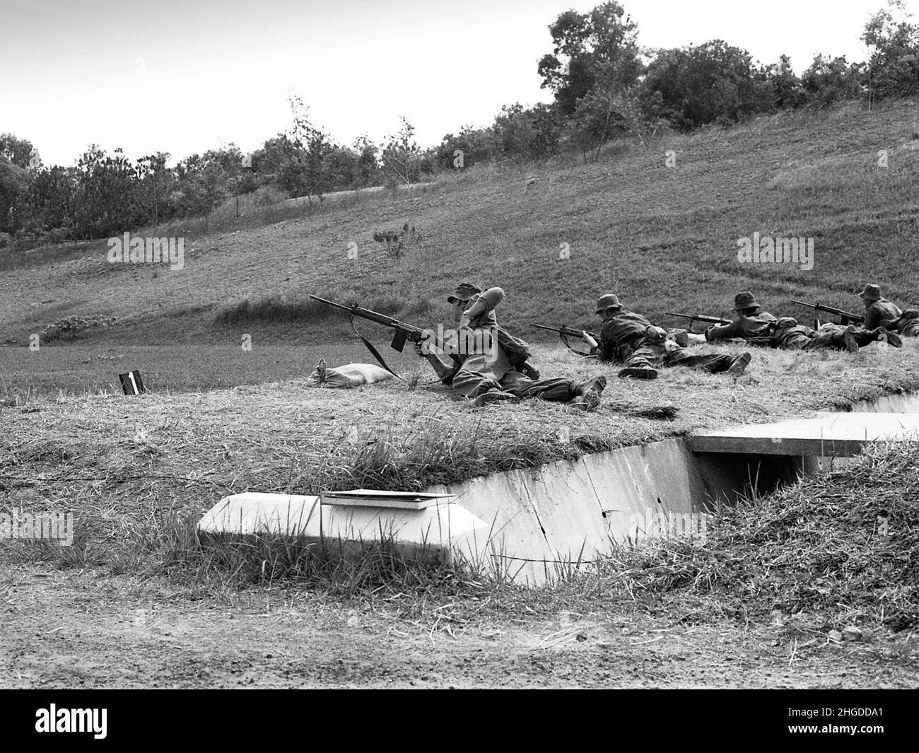 Royal Marines 42 Commando zeroeing weapons and changing magazines on the Madai ranges Singapore 1967 Stock Photo