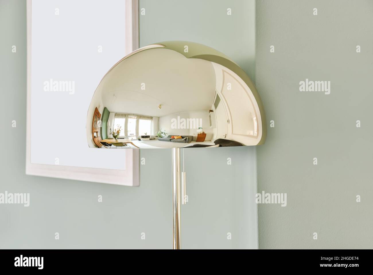 A delightful mirrored designer lamp reflecting the room Stock Photo