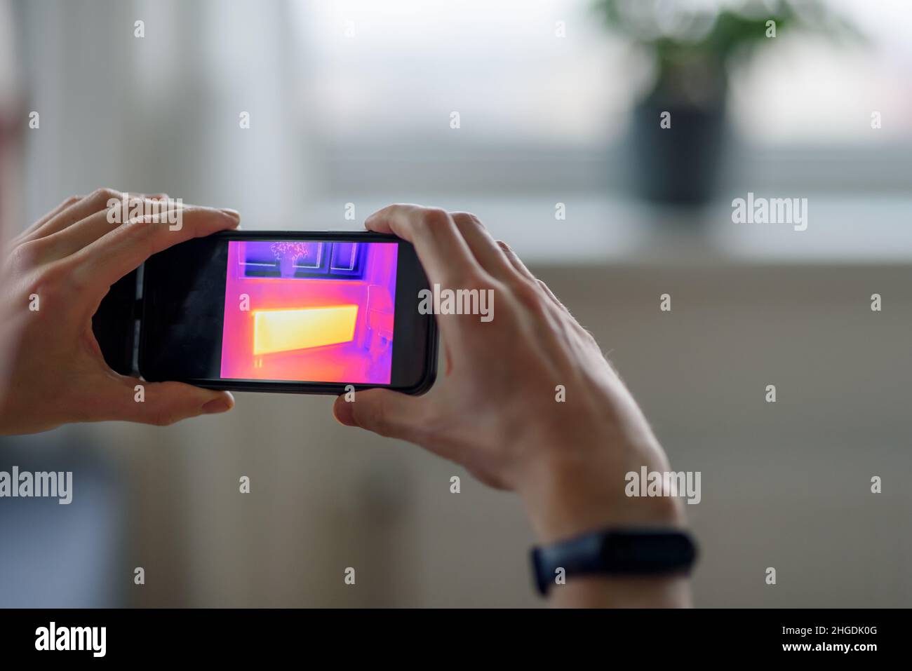 Curated visual reference: Fresh Look at Person Doing Thermal Scanning Or Imaging Of Apartment With Smartphone