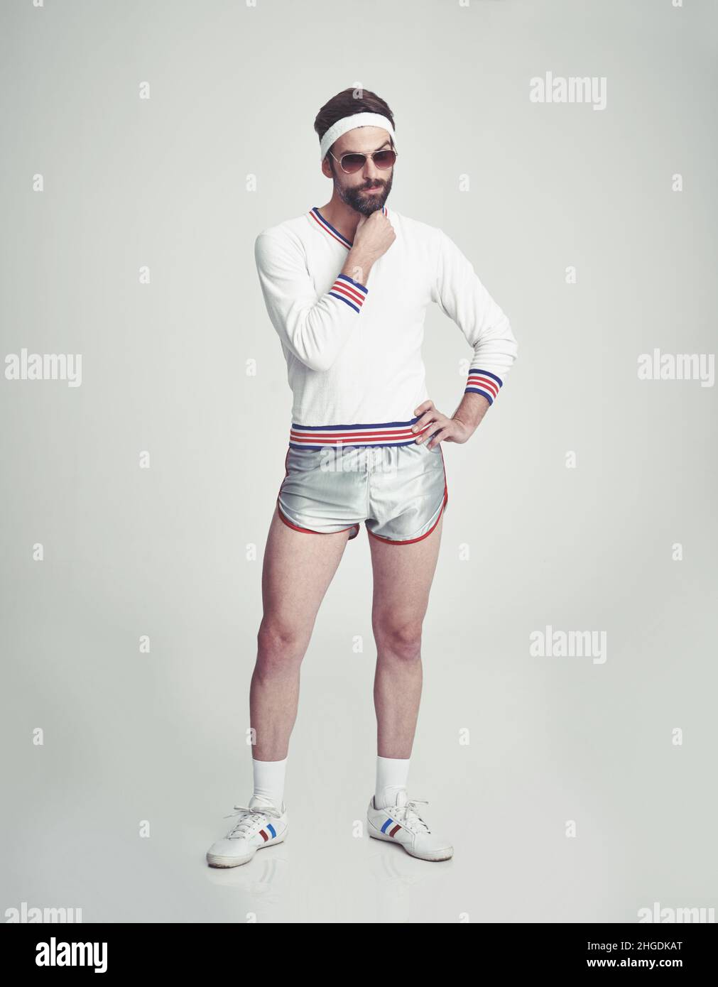 Your workout style needs work. A young man in the studio wearing retro sportswear and shades Stock Photo Alamy