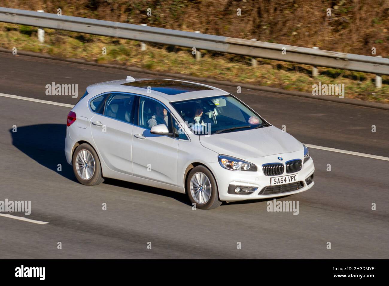 2014 white BMW 218 320D Efficientdynamics 1995cc 6 speed manual. Vehicular traffic, moving vehicles, cars, vehicle driving on UK roads, motors, motoring on the M61 motorway highway UK road network. Stock Photo