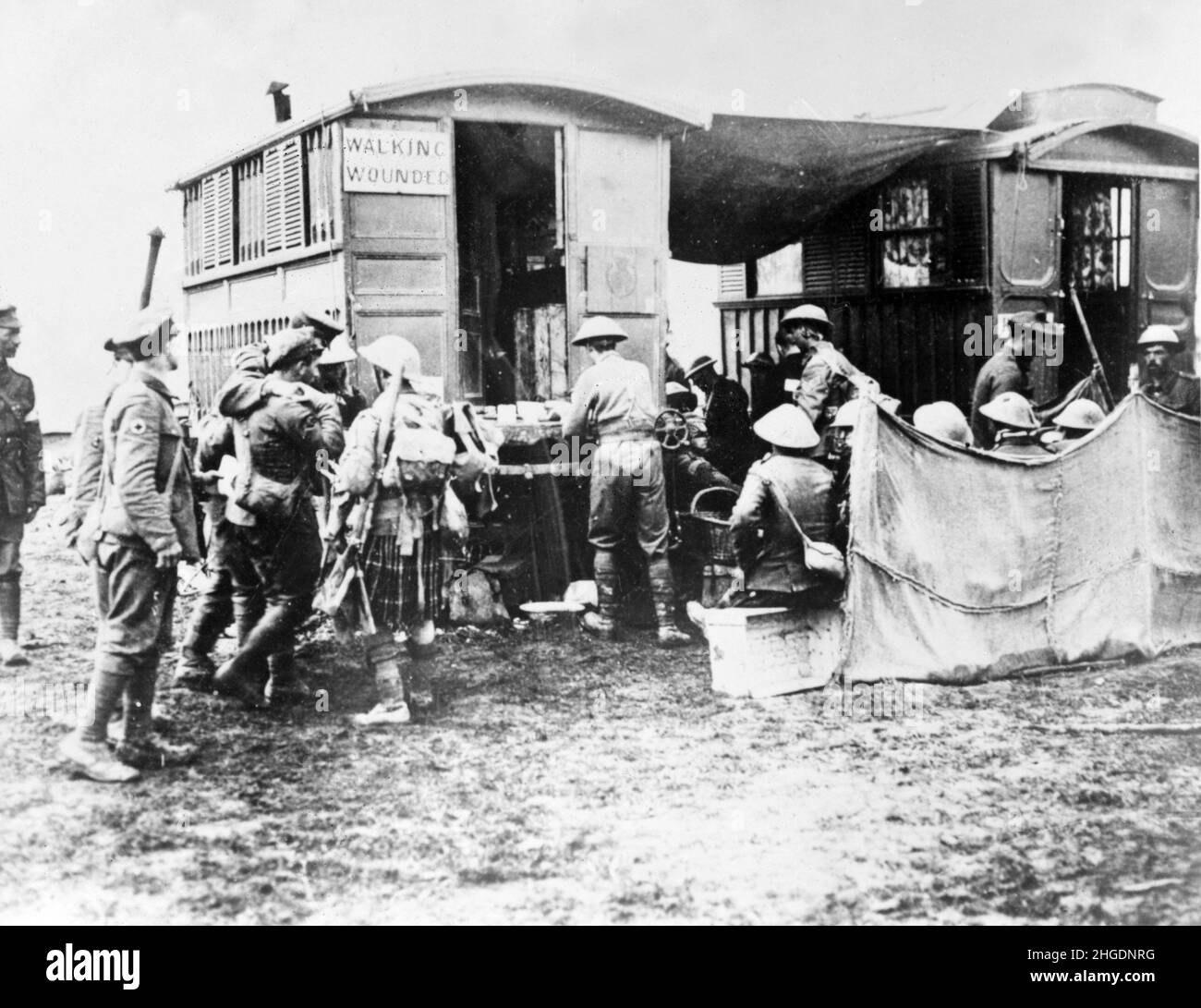 A vintage photo of British soldiers taking wounded men to a field dressing station on the Western front during world war one circa 1918. Stock Photo