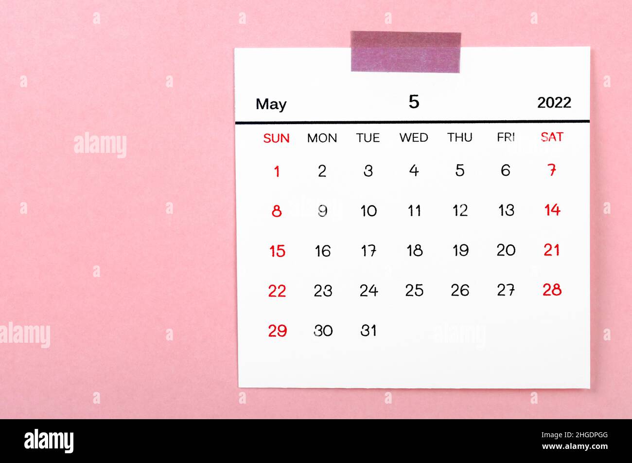 The May 2022 calendar on pink background. Stock Photo