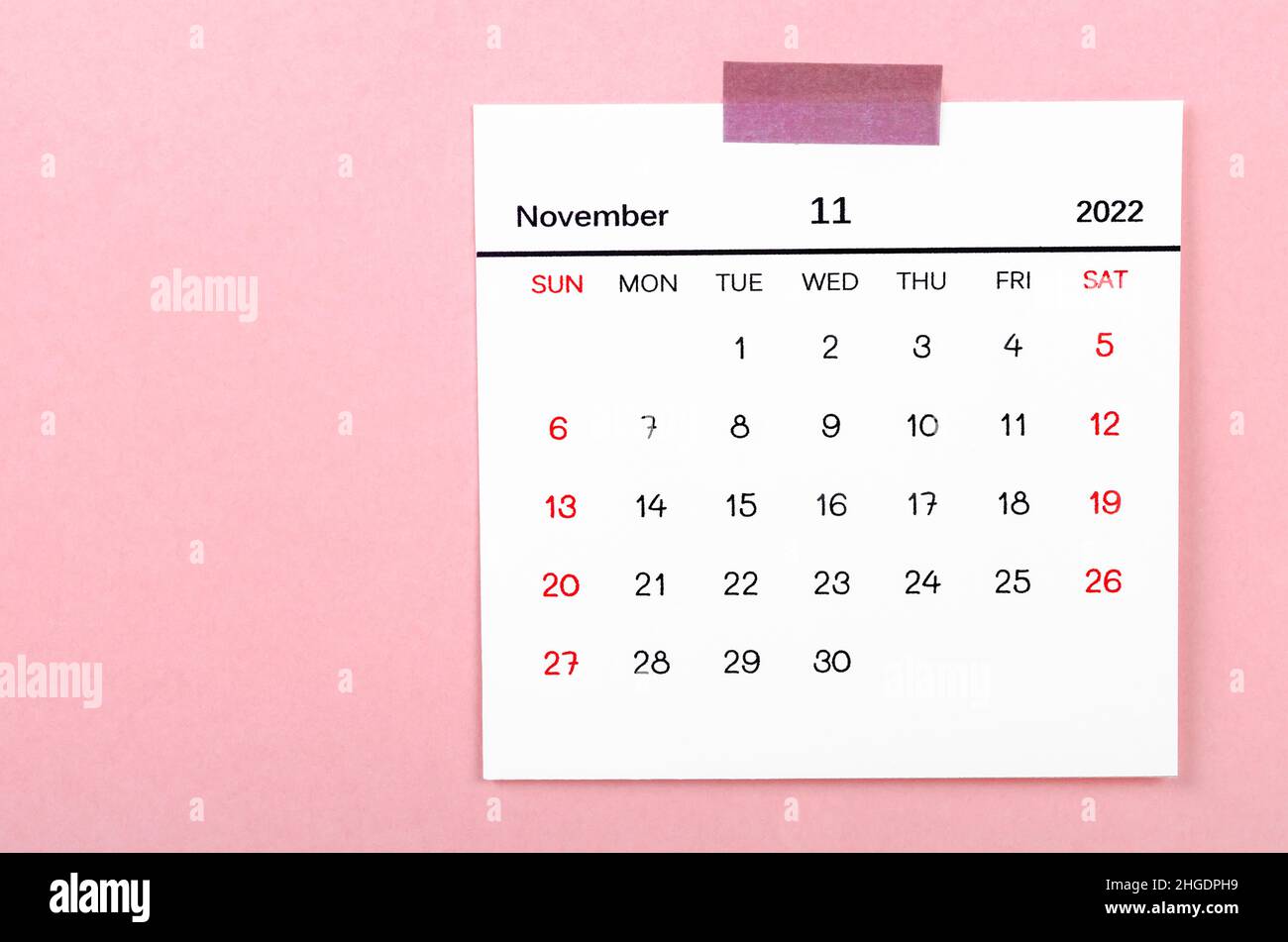 The November 2022 calendar on pink background. Stock Photo