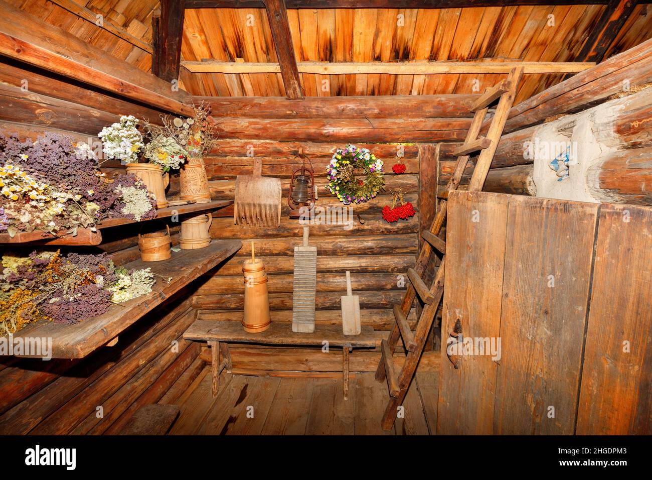 The utility room and the entrance hall of an old rural hut are filled with various household wooden utensils. Stock Photo