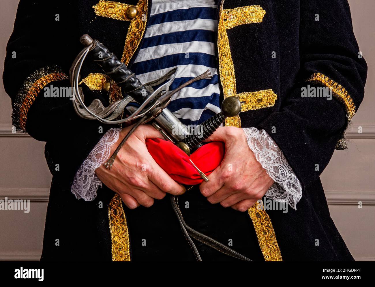 Brave armed pirate captain in a frock coat and vest with a sword and dagger close-up Stock Photo