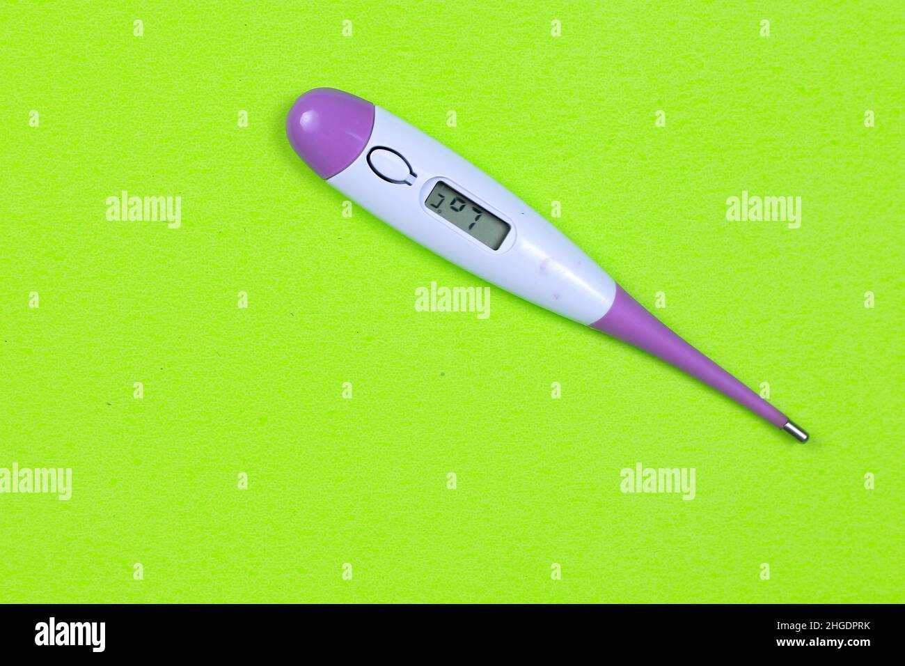 Body temperature thermometer on green background Stock Photo - Alamy