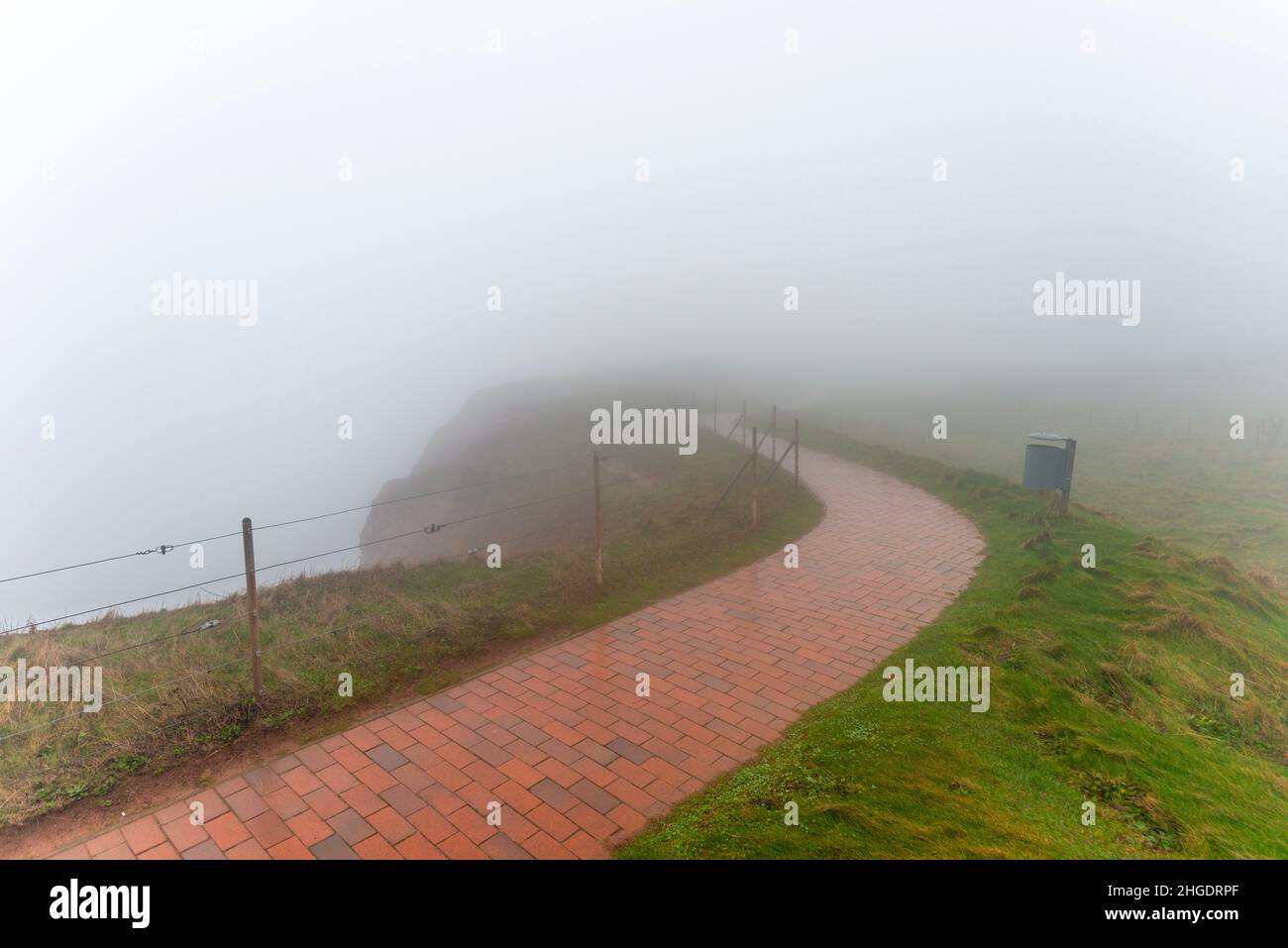 Path around the small island above the cliffs,dense fog on the high seas sland of Heligoland, North Sea, Northern Germany, Central Europe Stock Photo