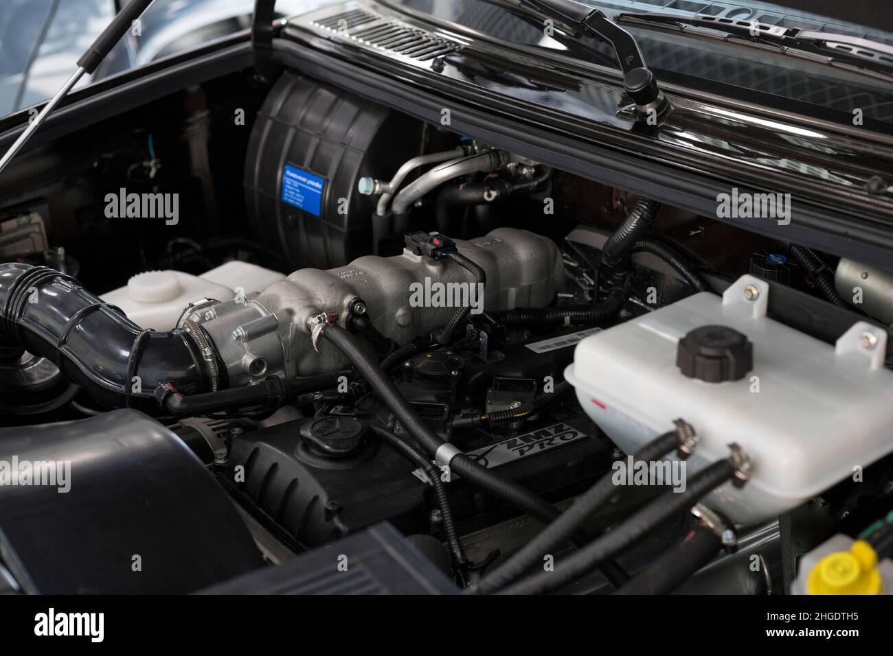 Russia, Izhevsk - August 20, 2021: UAZ showroom. Engine compartment of an internal combustion engine of new UAZ Patriot car. Sollers automotive group. Stock Photo