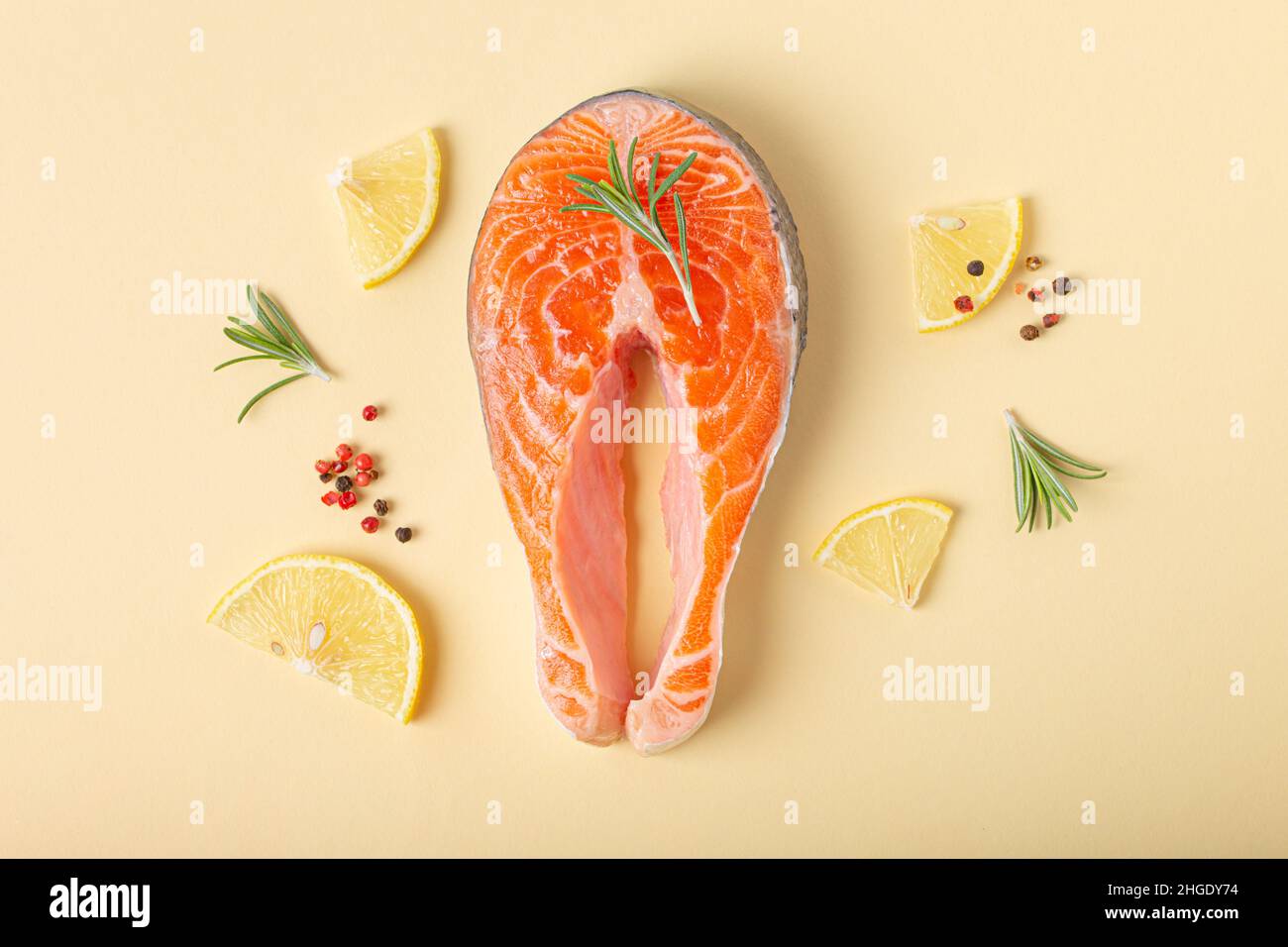 Raw fresh fish salmon steak top view on beige pastel background from above Stock Photo