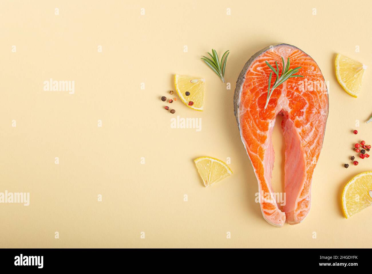 Raw fresh fish salmon steak top view on beige pastel background from above Stock Photo