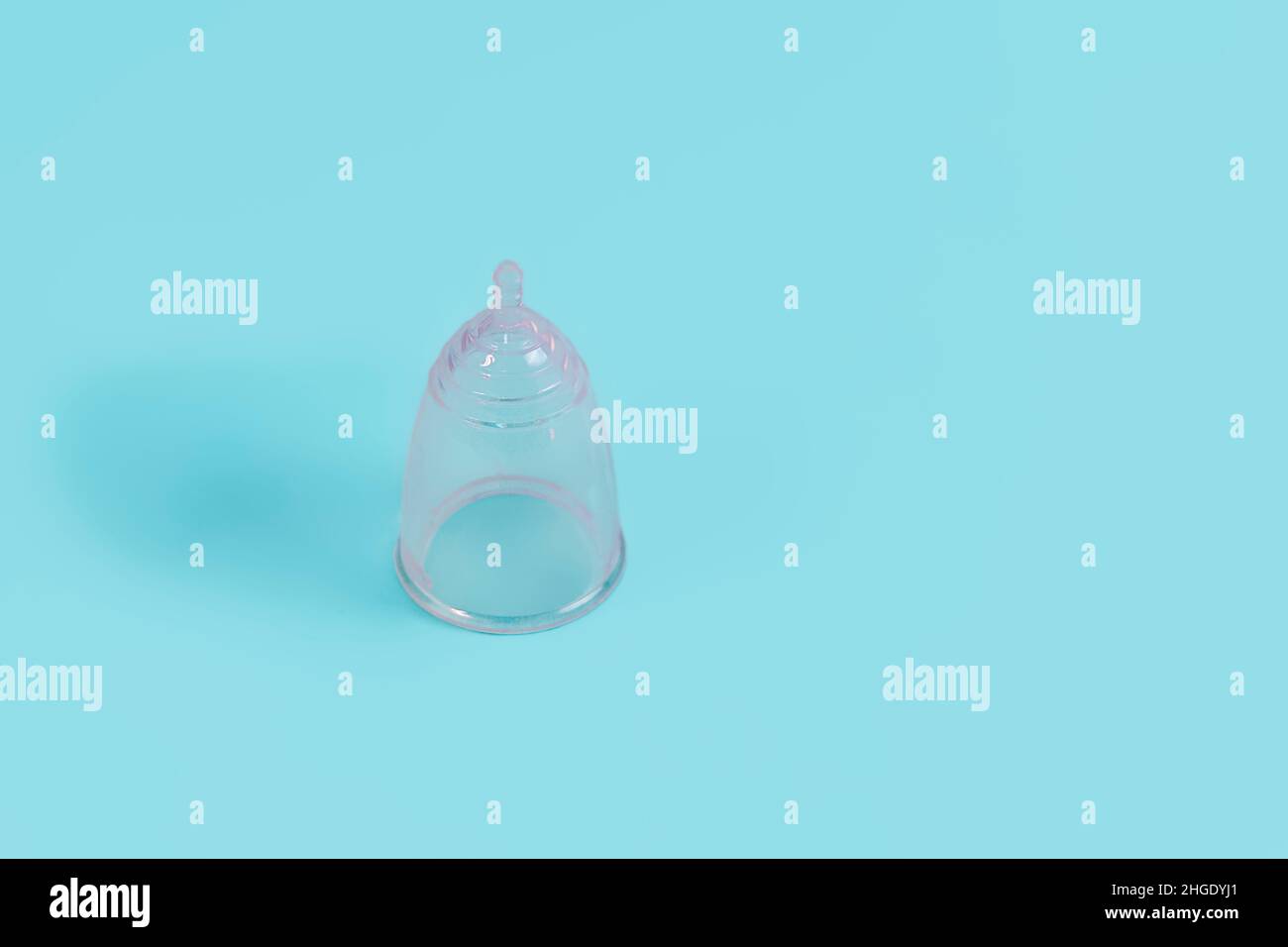 Eco-friendly menstrual cup on light blue background, copy space Stock Photo