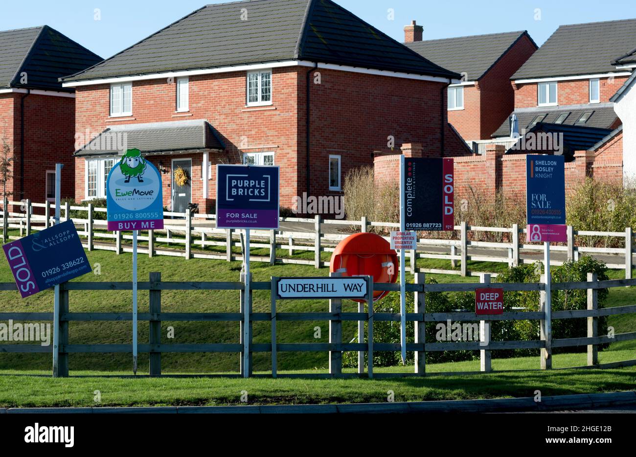 Estate agents boards by modern housing, Tachbrook, Warwickshire, England, UK Stock Photo