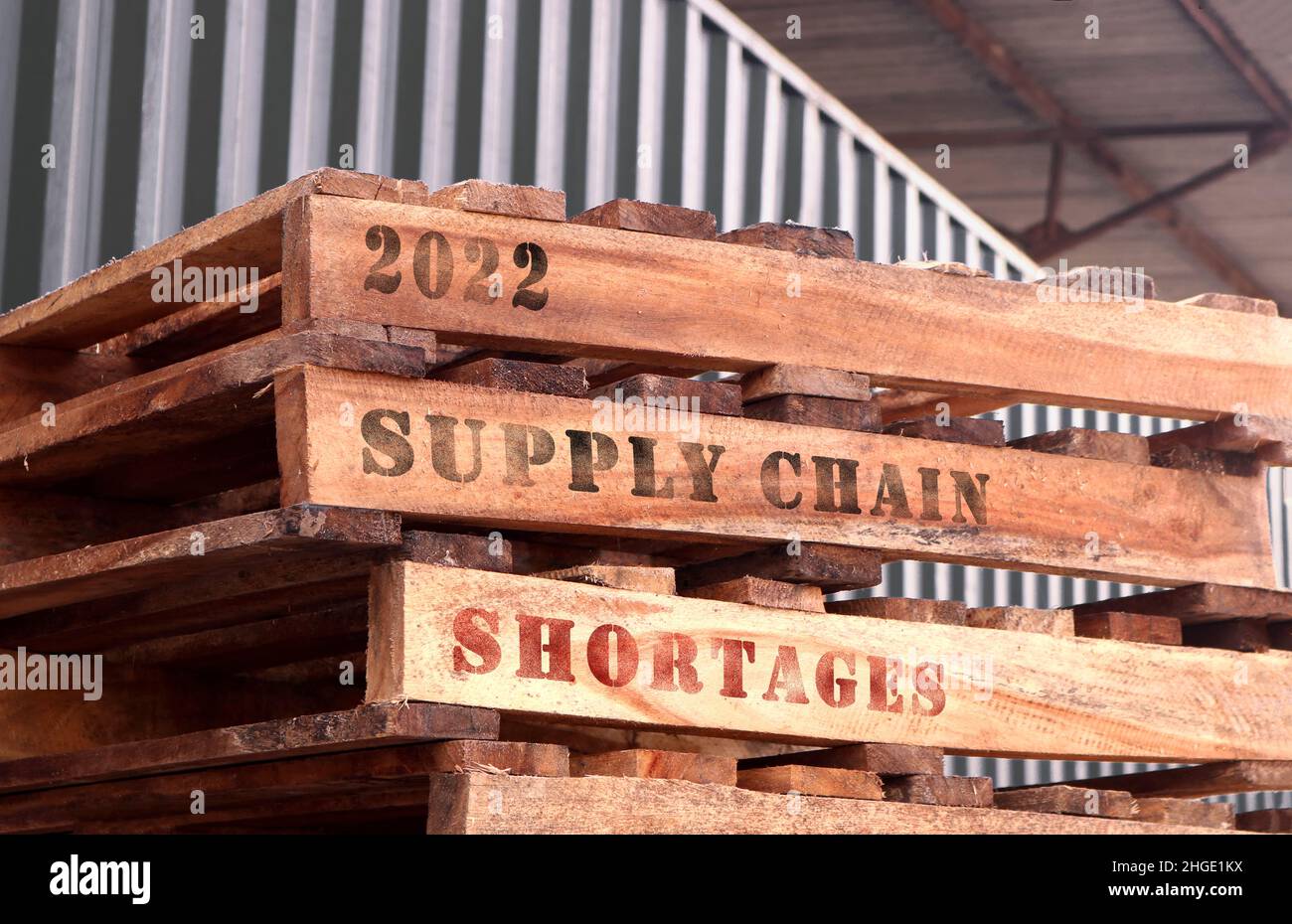 2022 Supply Chain Shortages, text written on piled up pallets. Supply chain concept. Stock Photo