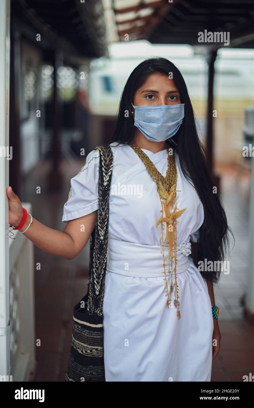 Portrait of young Arhuaco indigenous woman wearing a face mask during the Covid-19 outbreak in Colombia Stock Photo