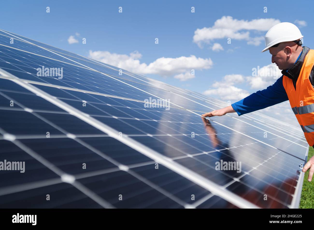 Solar power plant engineer makes a visual inspection of solar panels Stock Photo