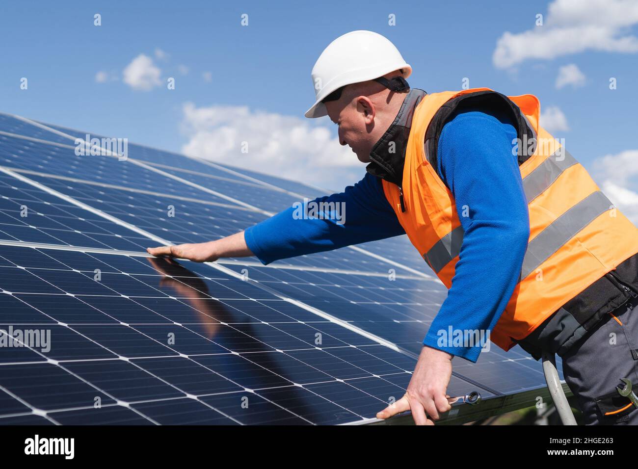 Solar power plant engineer makes a visual inspection of solar panels ...