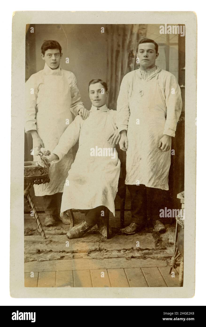 Original and probably rare studio portrait postcard of Staffordshire pottery workers. These young men are thought to be pottery workers as Fenton was a pottery town, one of the six that made up the 'Potteries' of  the city of Stoke on Trent. Perhaps they are the famous 'saggar makers bottom knockers' - an occupation that required unskilled young lads to knock the bottom of the saggar (Saggars were used to hold and protect pottery during kiln-firing), or the more skilled Frame Filler (an apprentice). Studio of L. Bowler, Foley Goldenhill Rd, Fenton, Stoke-on-Trent, Staffordshire, U.K. circa 191 Stock Photo